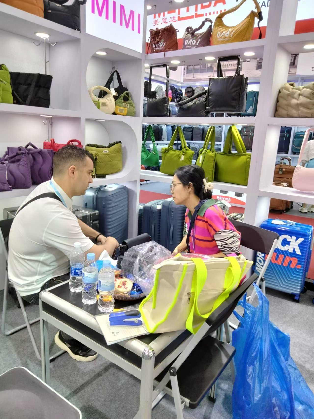 MAZ Outdoor discussing bag products with a buyer at a trade show